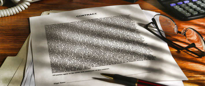Printed Legal Contract with File Folder on Wood Desk
